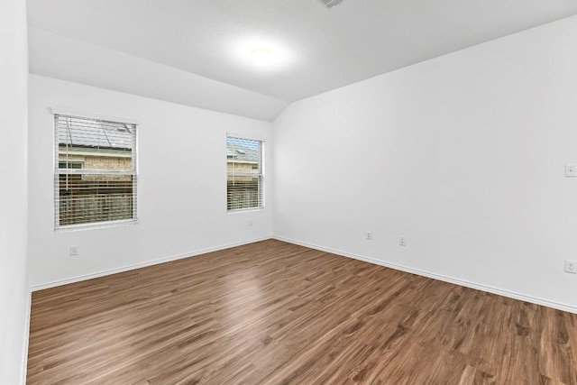 3201 Fresh Spring Rd, Pflugerville, TX 78660 - spare room featuring wood finished floors, vaulted ceiling, and baseboards