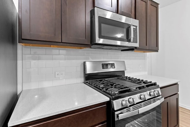 3201 Fresh Spring Rd, Pflugerville, TX 78660 - kitchen with stainless steel appliances, dark brown cabinetry, and decorative backsplash