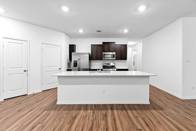 3201 Fresh Spring Rd, Pflugerville, TX 78660 - kitchen with appliances with stainless steel finishes, a sink, wood finished floors, light countertops, and recessed lighting