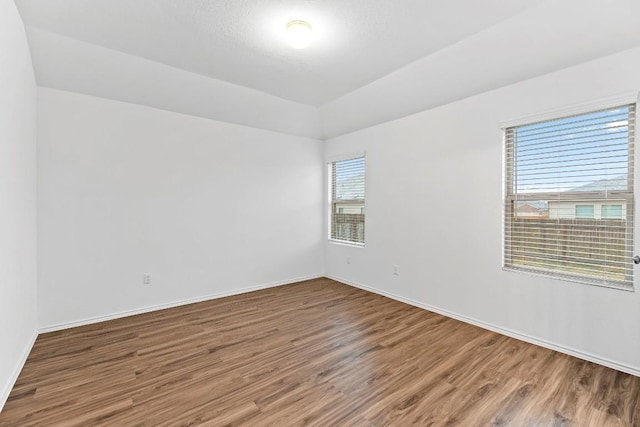 3201 Fresh Spring Rd, Pflugerville, TX 78660 - empty room with wood finished floors, baseboards, and vaulted ceiling
