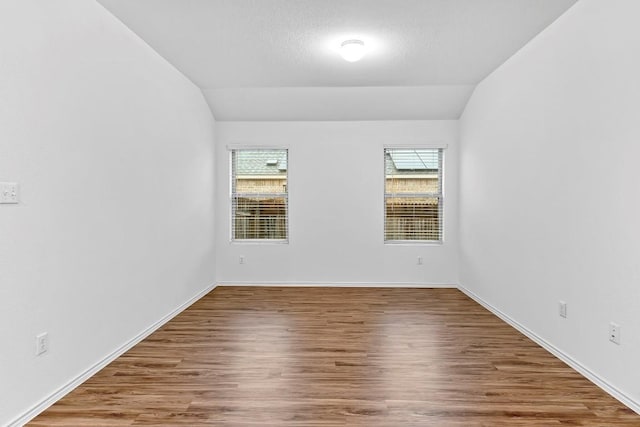 3201 Fresh Spring Rd, Pflugerville, TX 78660 - spare room with lofted ceiling, wood finished floors, and baseboards