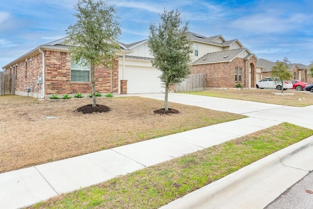 view of front of home with a garage and a front lawn