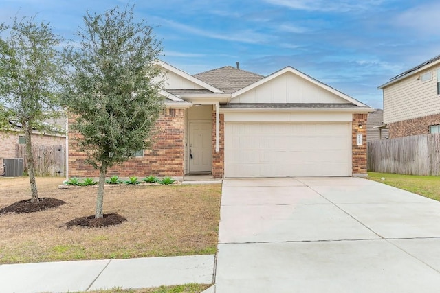 3201 Fresh Spring Rd, Pflugerville, TX 78660 - view of front facade with central AC unit, brick siding, a garage, and concrete driveway