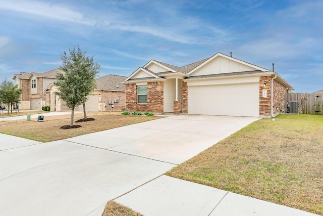 3201 Fresh Spring Rd, Pflugerville, TX 78660 - view of front of home with cooling unit, a garage, brick siding, and a front yard