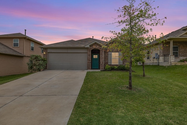 view of front of home with a garage and a lawn