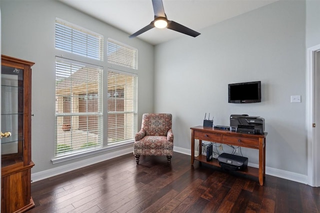 sitting room featuring dark wood-type flooring and ceiling fan