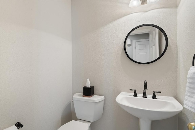 bathroom with toilet and sink