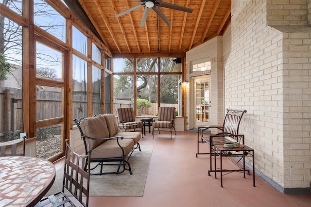 sunroom featuring beamed ceiling, ceiling fan, and wooden ceiling