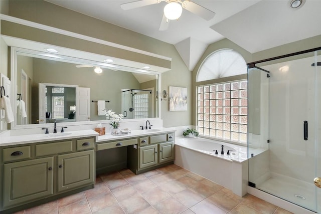 bathroom with ceiling fan, vanity, plus walk in shower, vaulted ceiling, and tile patterned floors