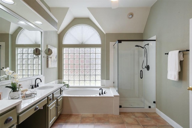 bathroom with vanity, tile patterned flooring, vaulted ceiling, and plus walk in shower