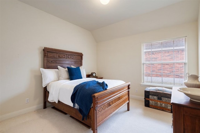 bedroom featuring vaulted ceiling and light carpet