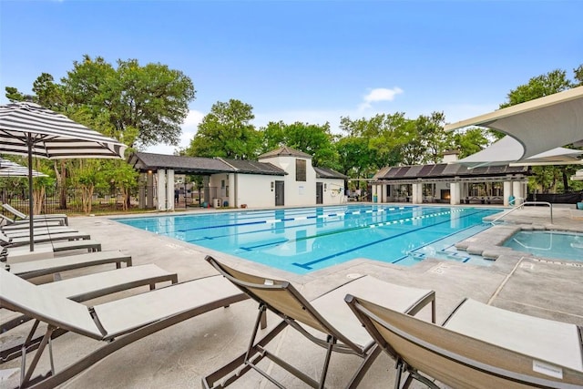 view of pool with a community hot tub and a patio area