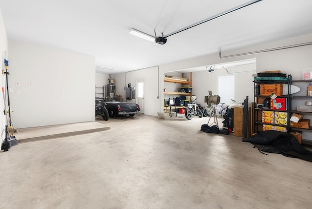 garage with a garage door opener and gas water heater