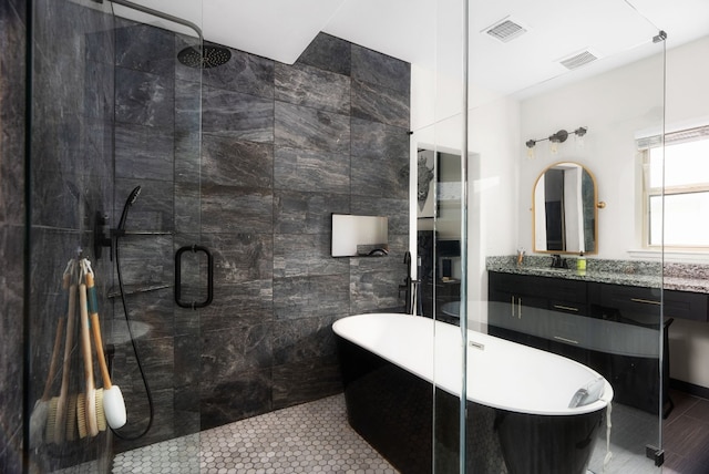 bathroom with vanity, tile patterned floors, tile walls, and separate shower and tub