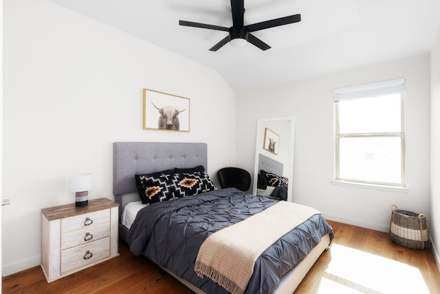 bedroom featuring wood-type flooring, ceiling fan, and vaulted ceiling