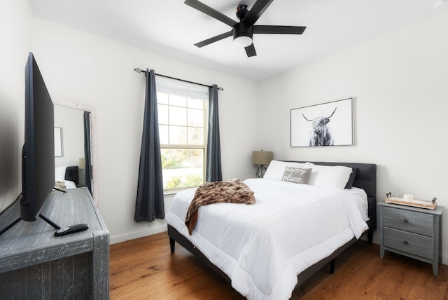 bedroom with dark wood-type flooring and ceiling fan