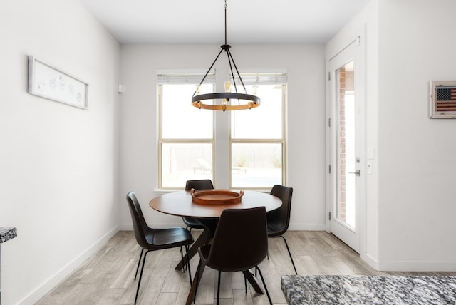 dining space with an inviting chandelier and light hardwood / wood-style floors