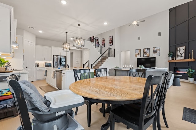 208 Tovas Secret Cv, Georgetown, TX 78628 - dining area featuring ceiling fan, stairway, recessed lighting, and a chandelier