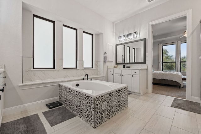 208 Tovas Secret Cv, Georgetown, TX 78628 - bathroom with vanity, a garden tub, and ceiling fan