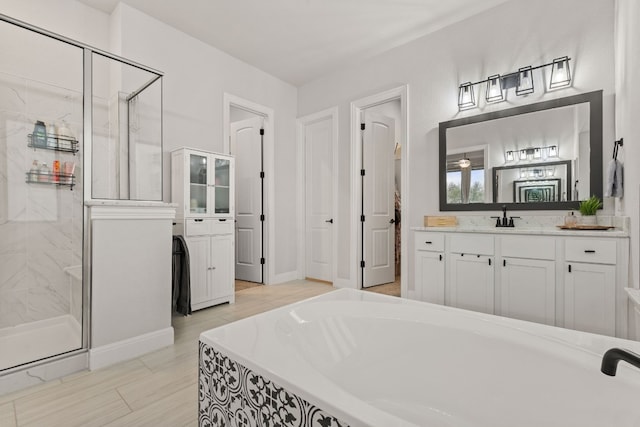 208 Tovas Secret Cv, Georgetown, TX 78628 - full bathroom with a shower stall, a bath, and vanity