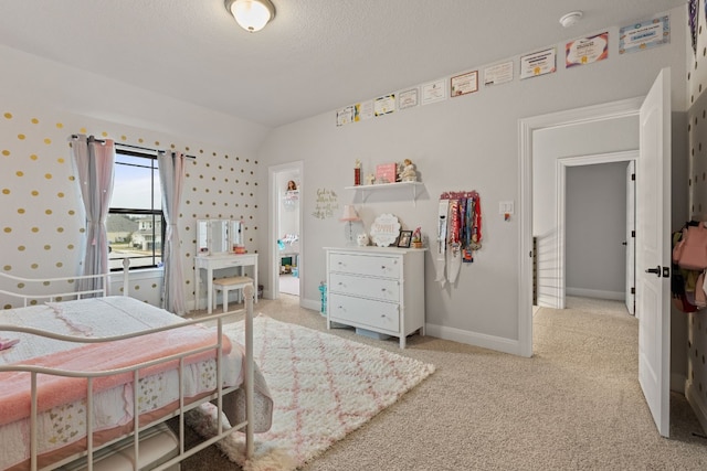 208 Tovas Secret Cv, Georgetown, TX 78628 - bedroom featuring light colored carpet, vaulted ceiling, and a textured ceiling