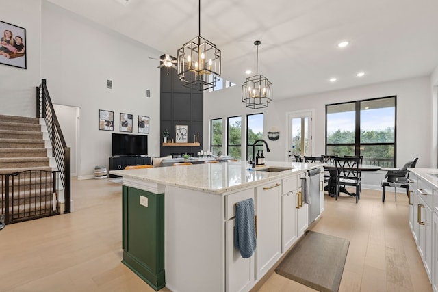 208 Tovas Secret Cv, Georgetown, TX 78628 - kitchen with white cabinetry, a chandelier, healthy amount of natural light, recessed lighting, and a towering ceiling