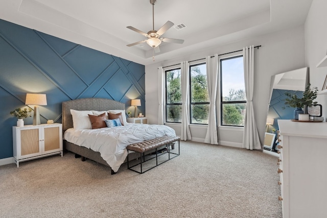 208 Tovas Secret Cv, Georgetown, TX 78628 - bedroom featuring light colored carpet, a raised ceiling, and ceiling fan