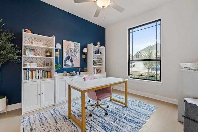 208 Tovas Secret Cv, Georgetown, TX 78628 - office space with an accent wall, a ceiling fan, and light wood-type flooring