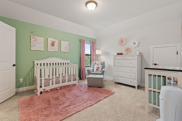 208 Tovas Secret Cv, Georgetown, TX 78628 - bedroom featuring carpet flooring, a crib, and a textured ceiling