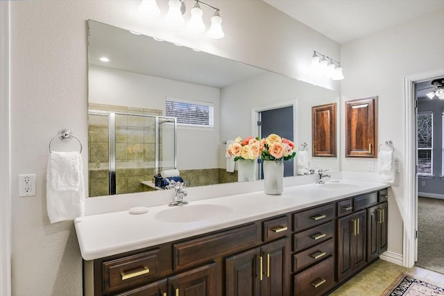 317 Yellow Rose Trl, Georgetown, TX 78633 - bathroom featuring double vanity, a stall shower, and tile patterned flooring
