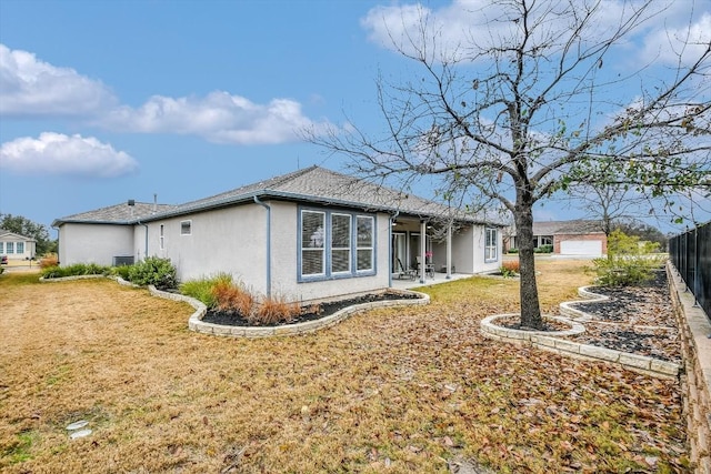 317 Yellow Rose Trl, Georgetown, TX 78633 - back of property with stucco siding, a patio area, and a garage