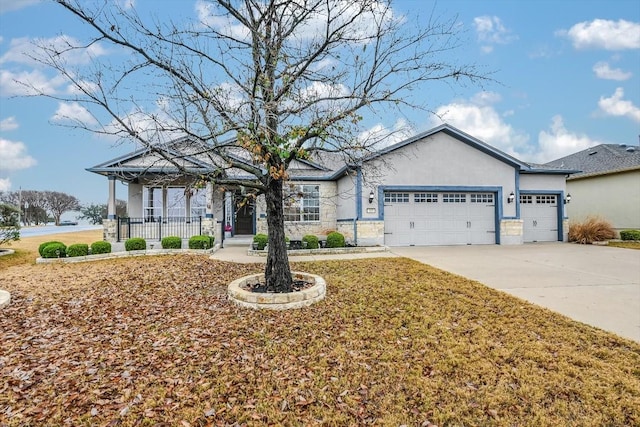 317 Yellow Rose Trl, Georgetown, TX 78633 - ranch-style house featuring an attached garage, concrete driveway, stucco siding, a porch, and stone siding