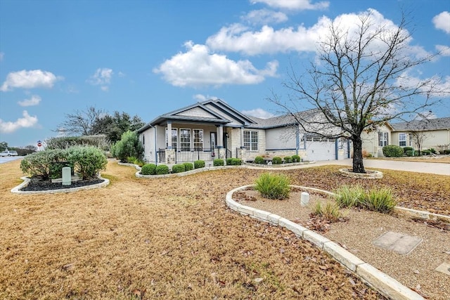 ranch-style home featuring a garage and covered porch