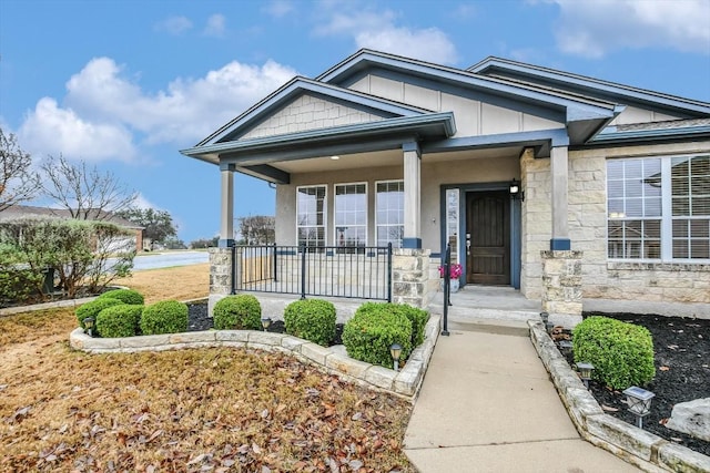 317 Yellow Rose Trl, Georgetown, TX 78633 - doorway to property with stone siding, a porch, and board and batten siding
