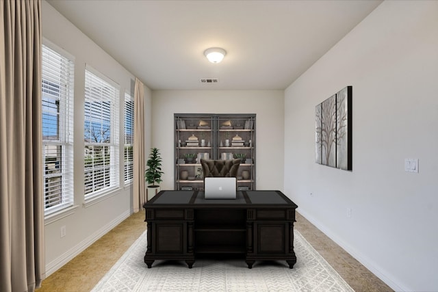 317 Yellow Rose Trl, Georgetown, TX 78633 - home office featuring baseboards and light carpet