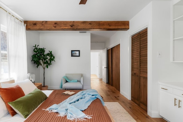 interior space featuring beam ceiling and light hardwood / wood-style flooring