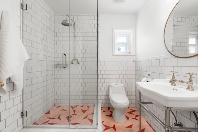 bathroom with an enclosed shower, tile walls, and toilet