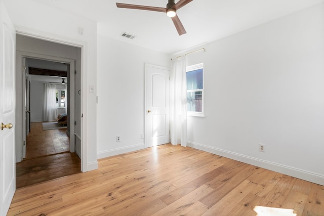 empty room with ceiling fan and light wood-type flooring