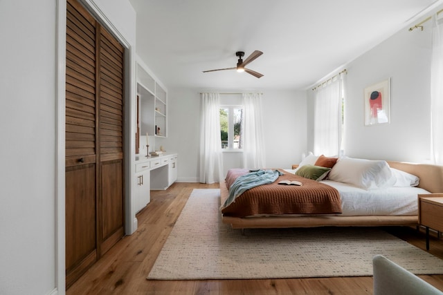 bedroom with ceiling fan and light hardwood / wood-style floors