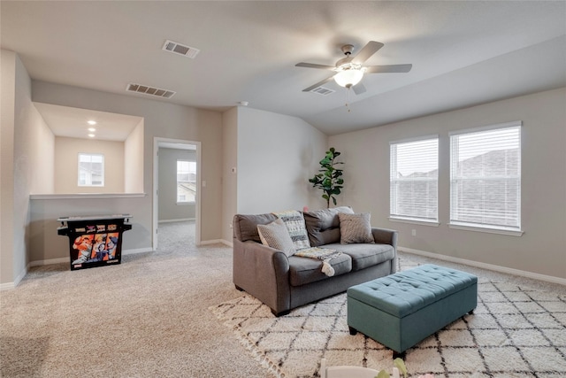 carpeted living room featuring vaulted ceiling and ceiling fan