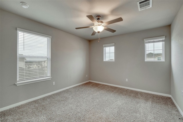 carpeted spare room with ceiling fan