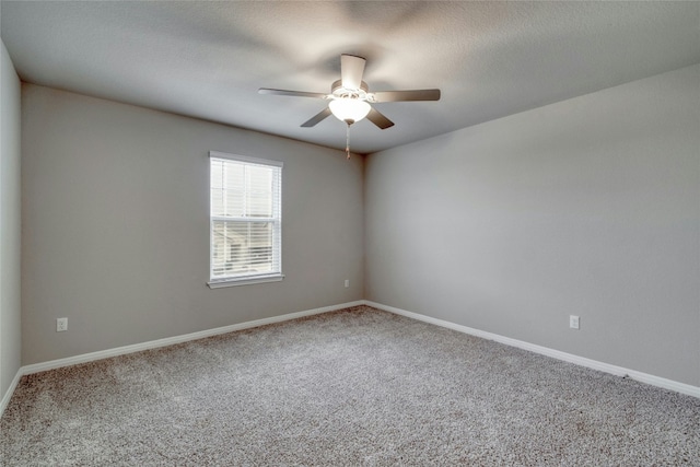 carpeted spare room with ceiling fan and a textured ceiling