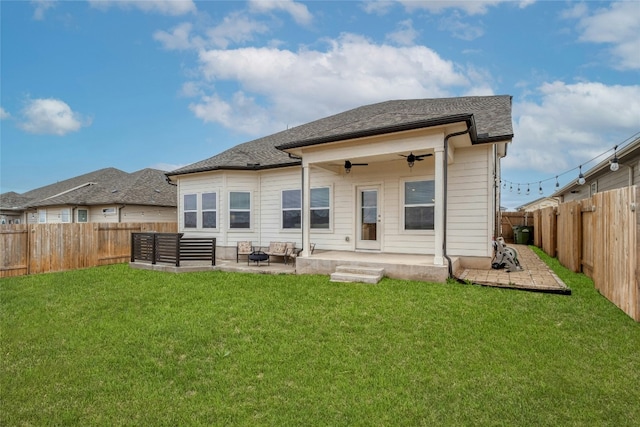 rear view of house featuring a patio, an outdoor living space with a fire pit, ceiling fan, and a lawn