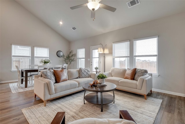 living room with ceiling fan, high vaulted ceiling, and hardwood / wood-style floors