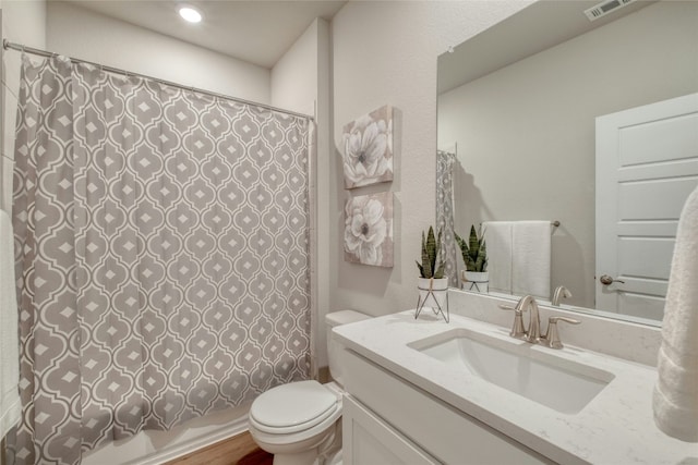 full bathroom featuring vanity, shower / bath combination with curtain, and toilet