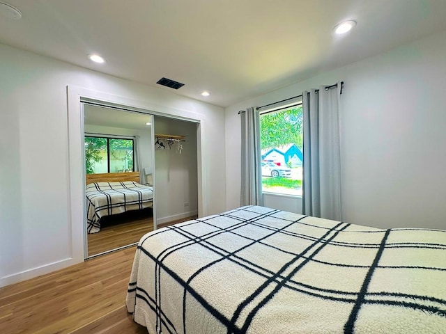 bedroom featuring recessed lighting, visible vents, multiple windows, and wood finished floors