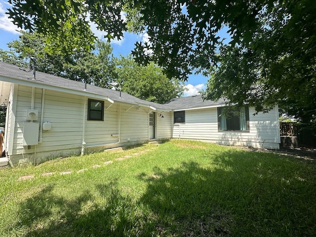 back of property with a lawn