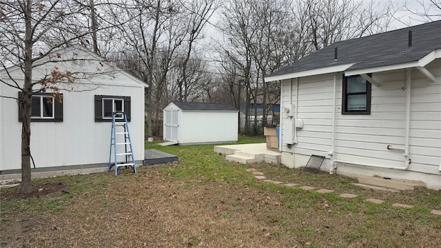 view of yard with a storage shed and an outbuilding