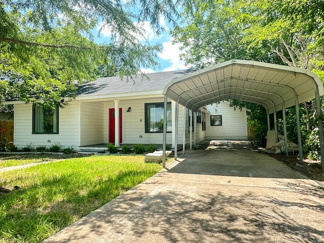 view of front of property with a detached carport, concrete driveway, and a front lawn