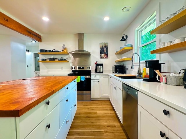 kitchen with open shelves, stainless steel appliances, and butcher block counters